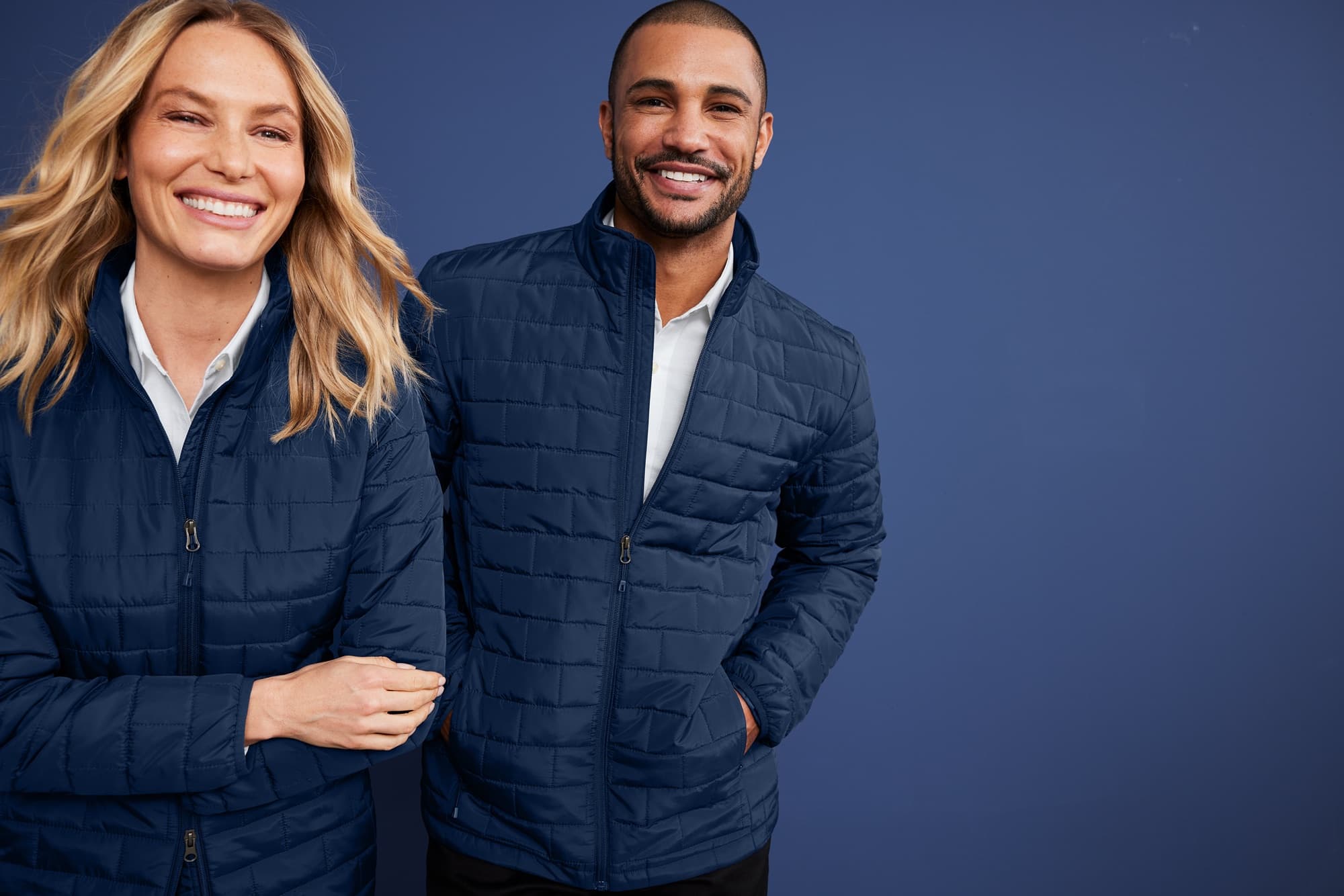 Two colleagues in navy quilted company jackets